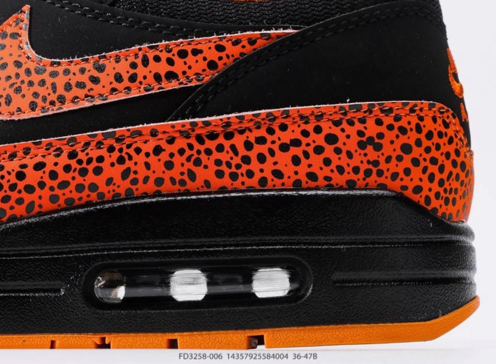 Nike Air Max 1 "Safari Orange and Black Grouper" (parfois répertoriée sous le code couleur noir et orange avec imprimé safari ou léopard)